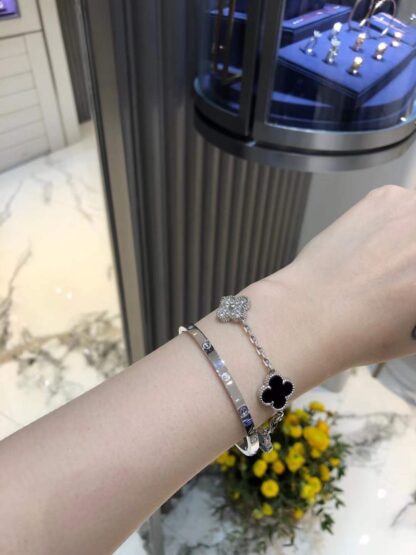 VCA Vintage Alhambra bracelet 5 motifs diamond white gold black onyx and Cartier Love bracelet pave diamonds